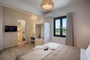 a bedroom with a large bed and a window at Vinebranch Villa in Vourvoulos