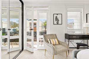 a living room with a desk and a chair at Central 2-Bed Terrace House by the Harbour in Sydney