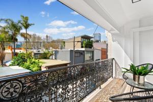 a balcony with a table and chairs on a building at Central 2-Bed Terrace House by the Harbour in Sydney