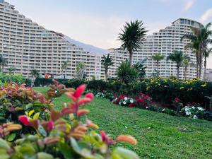 a large building with flowers and plants in a park at Chalet in Porto Sokhna Beach Resort in Ain Sokhna