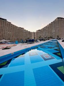 a large swimming pool in front of a large building at Chalet in Porto Sokhna Beach Resort in Ain Sokhna