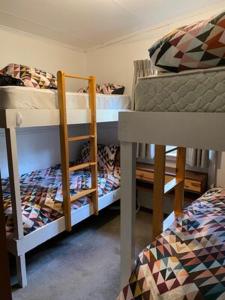 a room with two bunk beds and a bed at Nutcracker Ski Club in Mount Buller