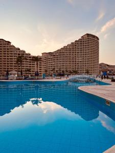 a large swimming pool in front of a hotel at Chalet in Porto Sokhna Beach Resort in Ain Sokhna