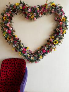 a heart shaped wreath with flowers on a wall at Hotel Caribe de Alter in Alter do Chao