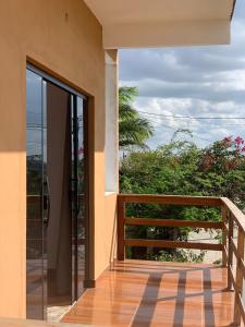 an open door to a balcony with a view at Chalé Aconchego da Serra in Serra de São Bento