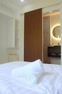 a white bed in a room with a piano at Boracay Luxury Apartments in Boracay