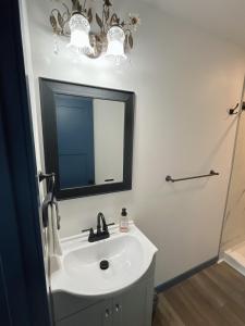 a bathroom with a sink and a mirror at Bugge Room 203, Hyland Hotel in Palmer