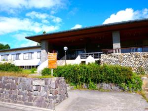 a building with a sign in front of it at LivingAnywhere Commons Aizu Bandai Mixed Dormitory - Vacation STAY 14957v in Inawashiro