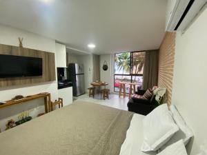 a bedroom with a bed and a living room at Beautiful Accommodation - #Unity Flats Cabo Branco in João Pessoa