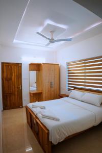 a bedroom with a large bed with a ceiling at Muthanga Wild Resort in Muthanga