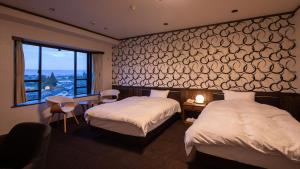 Ένα ή περισσότερα κρεβάτια σε δωμάτιο στο Aso Hotel