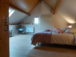 a bedroom with a large bed in a attic at Retraite Champêtre avec Jardin, Piscine et Proximité Château à Châteaudun - FR-1-581-134 in Châteaudun +27 photos