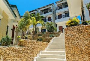 a staircase leading to a building with palm trees at RedDoorz @ LM Apartelle Boracay in Boracay