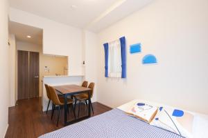 a bedroom with a bed and a table and chairs at G-Stage 01 IKEBUKURO in Tokyo +87 photos