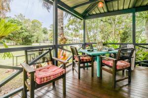 a patio with a table and chairs on a deck at The Little House - Pet-friendly beach cottage in Agnes Water