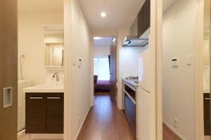 a small kitchen with a sink and a counter at G-Stage 01 IKEBUKURO in Tokyo
