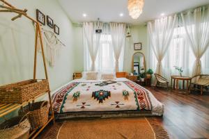 a bedroom with a bed and a table and chairs at MiaCasaHanoi in Hanoi