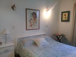 a bedroom with a bed with a pillow on it at Holiday Home Dark Green House in Chacras de Coria