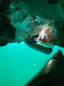 a group of people in a kayak in a cave at Tiny House Cat Ba in Cat Ba