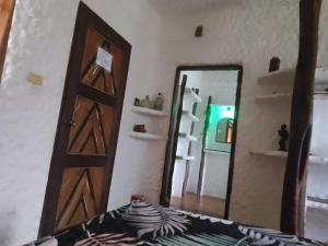 a room with a door and a mirror at Bambua Nature Cottages in Puerto Princesa City