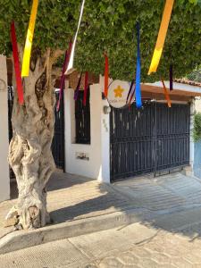 a tree with colorful flags hanging from a fence at Casa Mayo B&B in Oaxaca City