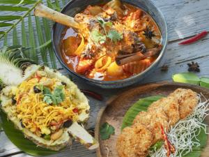 a table with a bowl of soup and a plate of food at Explorar Koh Phangan - Adults Only Resort and Spa in Haad Rin