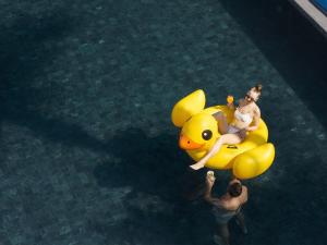a group of people riding on a yellow duck in the water at Explorar Koh Phangan - Adults Only Resort and Spa in Haad Rin