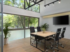 an office with a conference room with a table and chairs at Explorar Koh Phangan - Adults Only Resort and Spa in Haad Rin