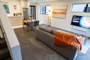a living room with a couch and a table at Tranquil 2 bed townhouse w/carparking in Christchurch