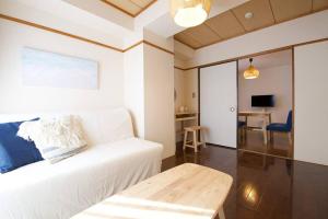 a living room with a white couch and a table at NH building5F in Tokyo