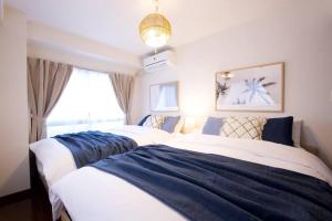 a bedroom with two beds and a window at NH building5F in Tokyo