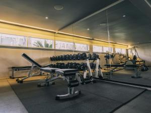 a gym with two tread machines and a mirror at Explorar Koh Phangan - Adults Only Resort and Spa in Haad Rin