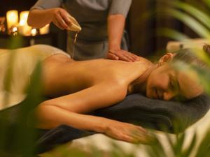 a woman getting a massage in a towel at Explorar Koh Phangan - Adults Only Resort and Spa in Haad Rin