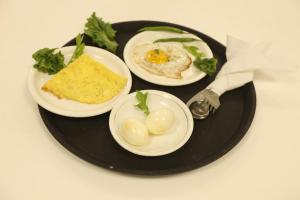 a plate with three plates of food on a table at Country Inn & Suites By Umrb - Mumbai International Airport in Mumbai