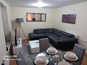 a living room with a couch and a table at POTTERS LOGDE LIVERPOOL by Edl Ventures Ltd in Liverpool +16 photos
