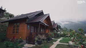 a wooden house with a pathway in front of it at Puncak Lestari Villa Bedugul by BIJAK in Bedugul