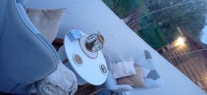 a person is standing next to a table with a white tableablish at Hé Ma Bulle in Pleugueneuc