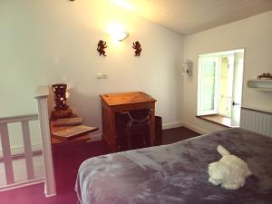 a bedroom with a bed and a desk and a window at TERRE d'HISTOIRE - Baignade - Canoë - Piste cyclable à 100 m in Castelnaud La Chapelle