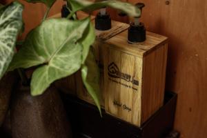 a wooden box sitting next to a plant at Gateway inn Puluong in Thanh Hóa