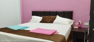 a bed with two towels sitting on top of it at HOTEL AYODHYA PAYING GUEST in Ayodhya