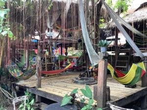 a bunch of hammocks on a wooden deck at Sook Jai Guest House in Chiang Rai