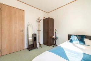 Postel nebo postele na pokoji v ubytování Travel Palace Miyuki