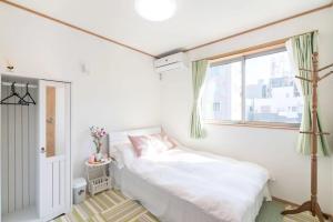 Postel nebo postele na pokoji v ubytování Travel Palace Miyuki