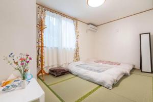 Postel nebo postele na pokoji v ubytování Travel Palace Miyuki