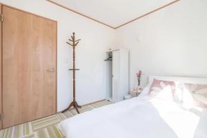 Postel nebo postele na pokoji v ubytování Travel Palace Miyuki