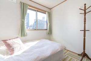 Postel nebo postele na pokoji v ubytování Travel Palace Miyuki
