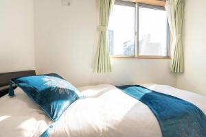 Postel nebo postele na pokoji v ubytování Travel Palace Miyuki