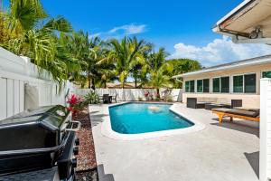 a swimming pool in the backyard of a house at Gorgeous open concept 4 BR with heated pool and lounge area in Fort Lauderdale +47 photos