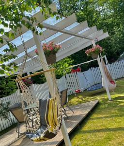 a porch with a hammock under a white umbrella at Casuta cu amintiri in Cîmpulung