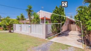 a house with a volleyball net in front of it at Yamba Daze Sunset in Yamba